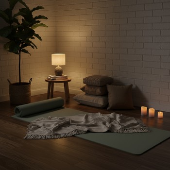 Small home yoga corner in the evening light with a mat and lamp